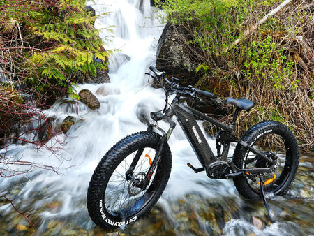 Himiway all-terrain electric bike sitting on a beautiful waterfall.